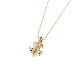 The picture shows a large 14K yellow gold fleur de lis pendant with hand engravings.