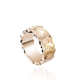 The picture shows a 14K yellow gold cut out 8 mm ring with hand engravings including sea turtles.