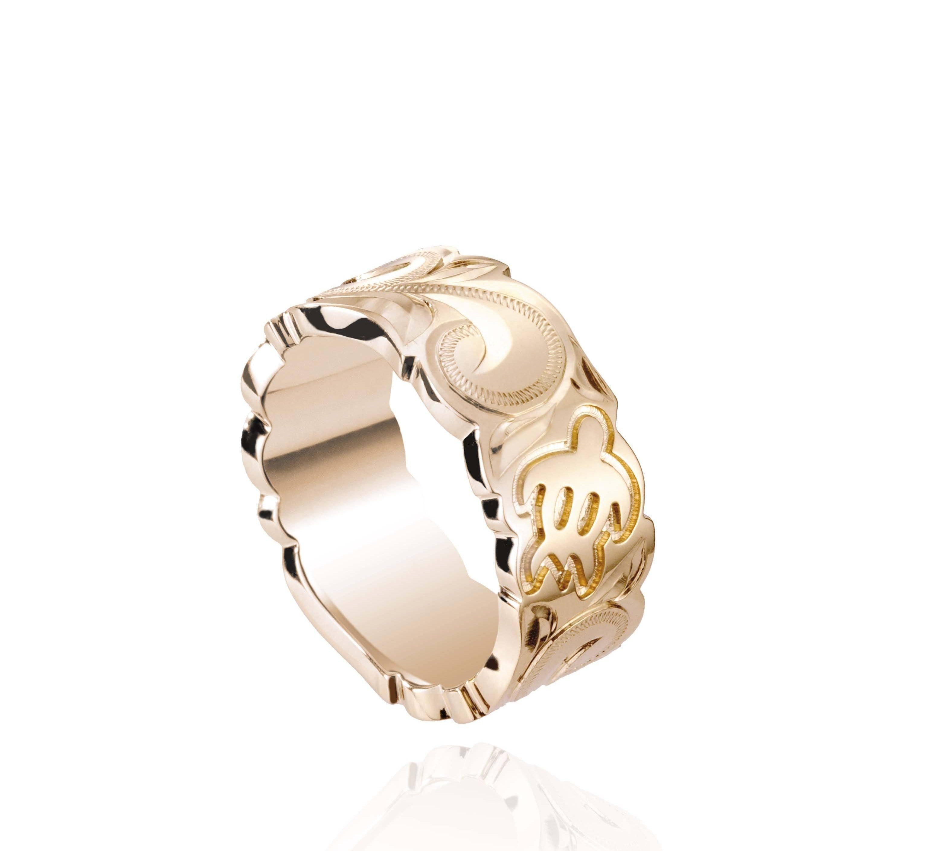 The picture shows a 14K yellow gold cut out 8 mm ring with hand engravings including sea turtles.