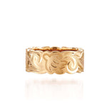 The picture shows a 14K yellow gold cut out 8 mm ring with hand engravings including sea turtles.