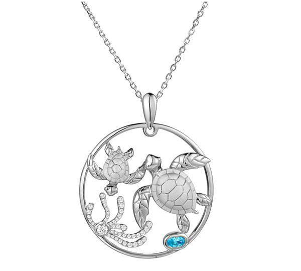The picture shows a 14K white circle pendant featuring two sea turtles, sea weed of diamonds and  aquamarine.