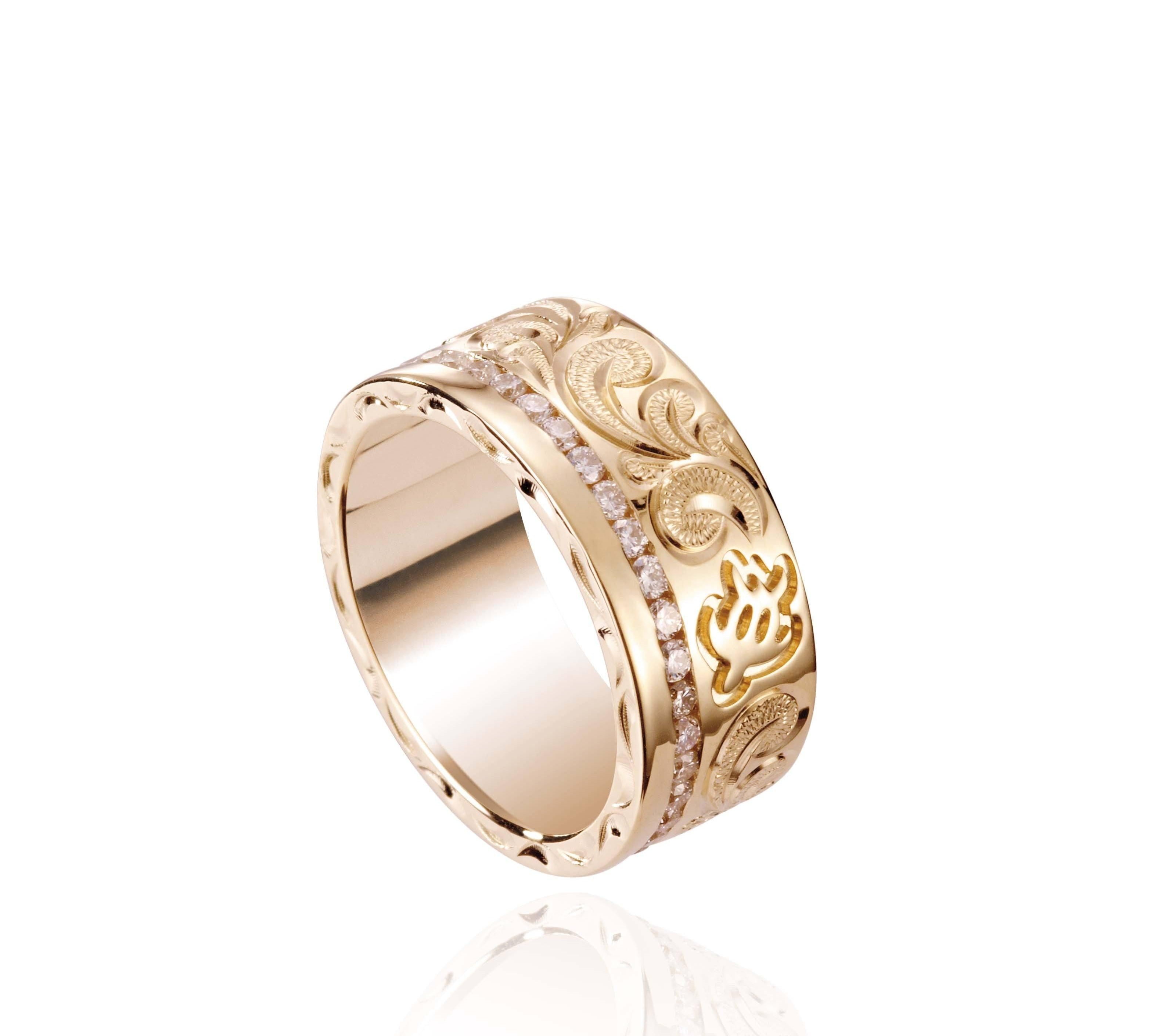 The picture shows a 14K yellow gold diamond Channel 8 mm ring with hand-engravings, including a sea turtle.