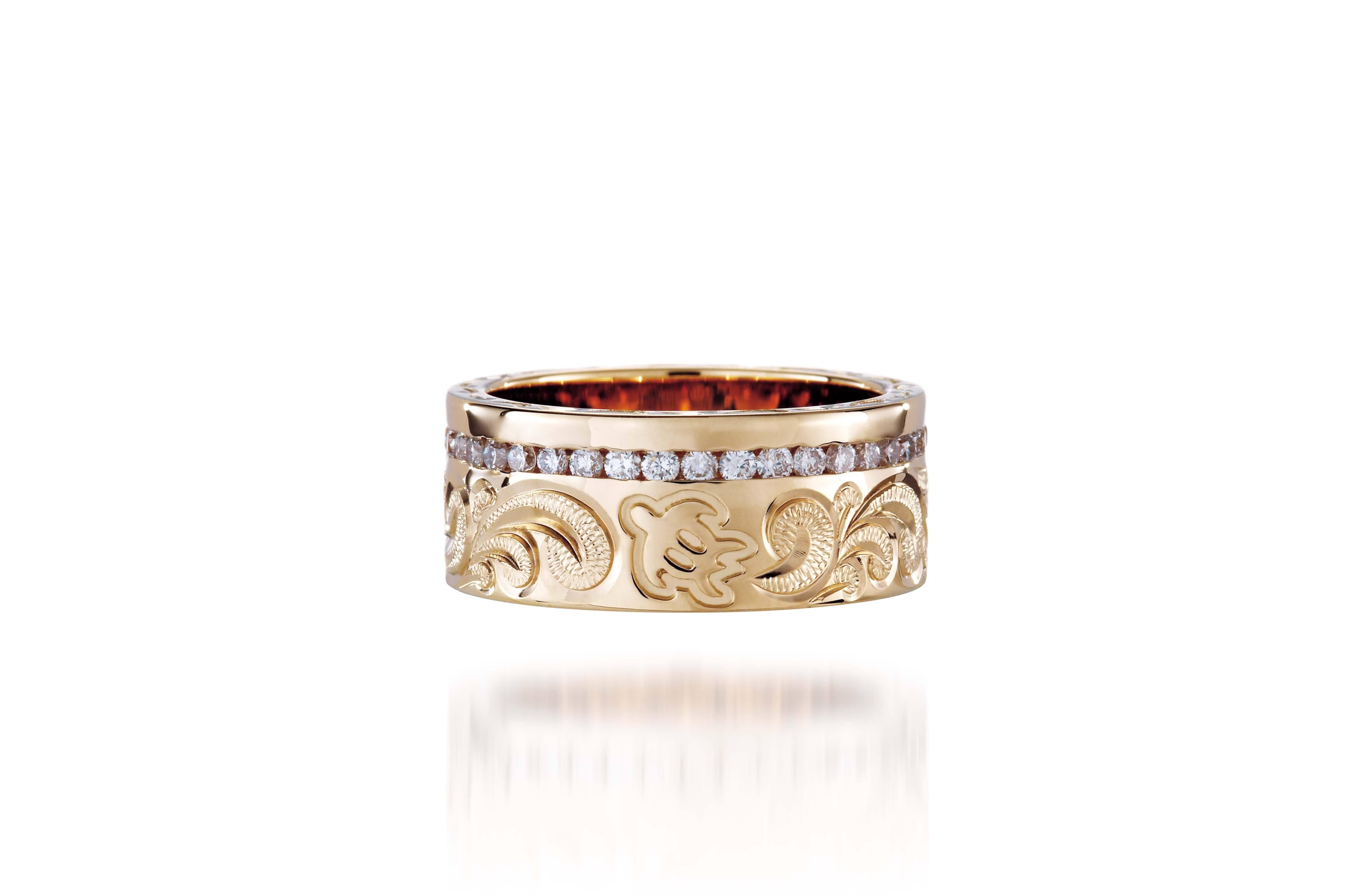 The picture shows a 14K yellow gold diamond Channel 8 mm ring with hand-engravings, including a sea turtle.