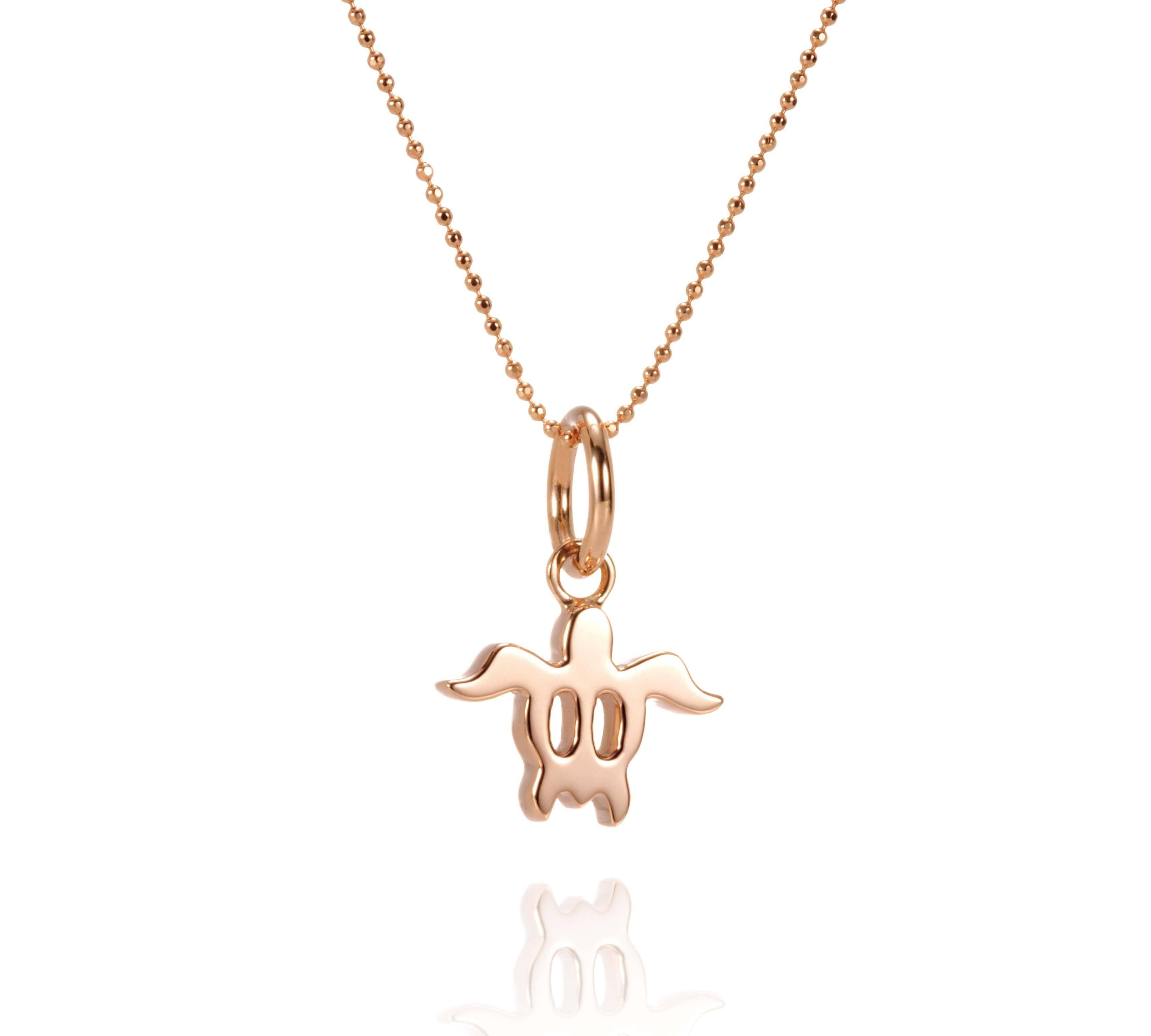 The picture shows a 14K rose gold sea turtle pendant.