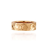 The photo shows a 6 mm 14K yellow gold ring with hand engravings including sea turtles.