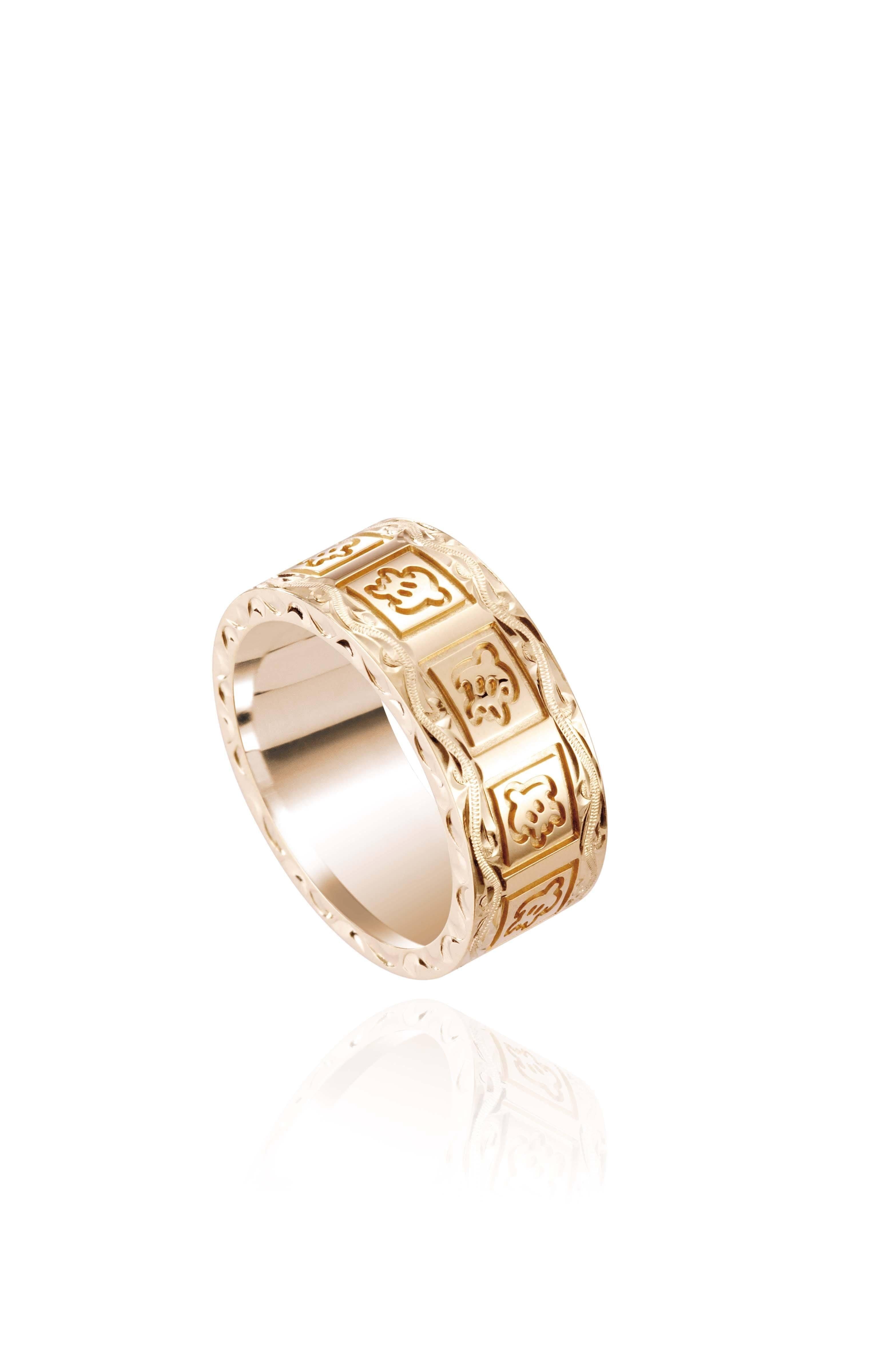 The picture shows a 14K yellow gold 8 mm ring with hand engravings including sea turtles.