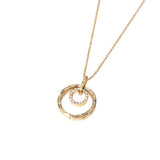 The picture shows a 14K yellow gold two circle infinity scroll pendant with hand engravings and diamonds.
