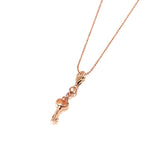 The picture shows a 14K yellow gold key charm with hand-engraved detailing.