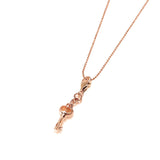 The picture shows a 14K yellow gold key charm with hand-engraved detailing.