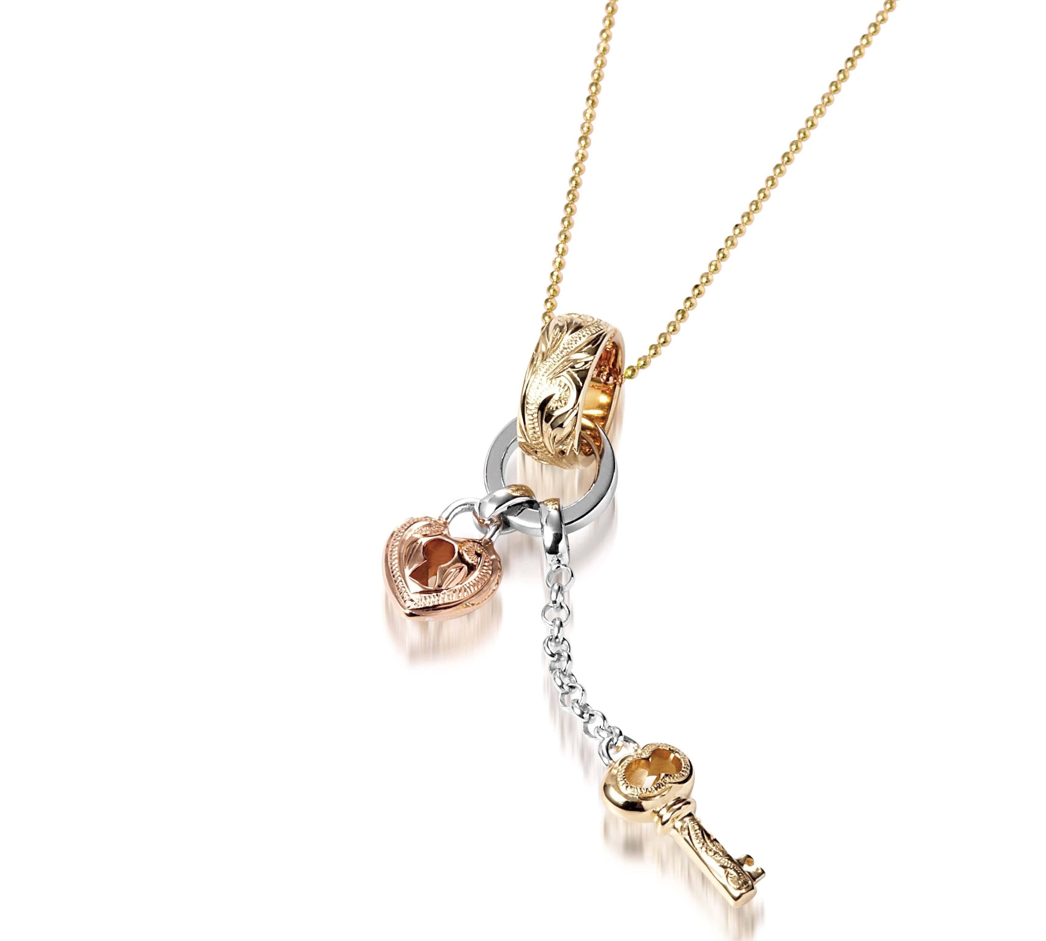 The picture shows a 14K yellow, rose, and white gold key and lock charm pendant with hand engravings.