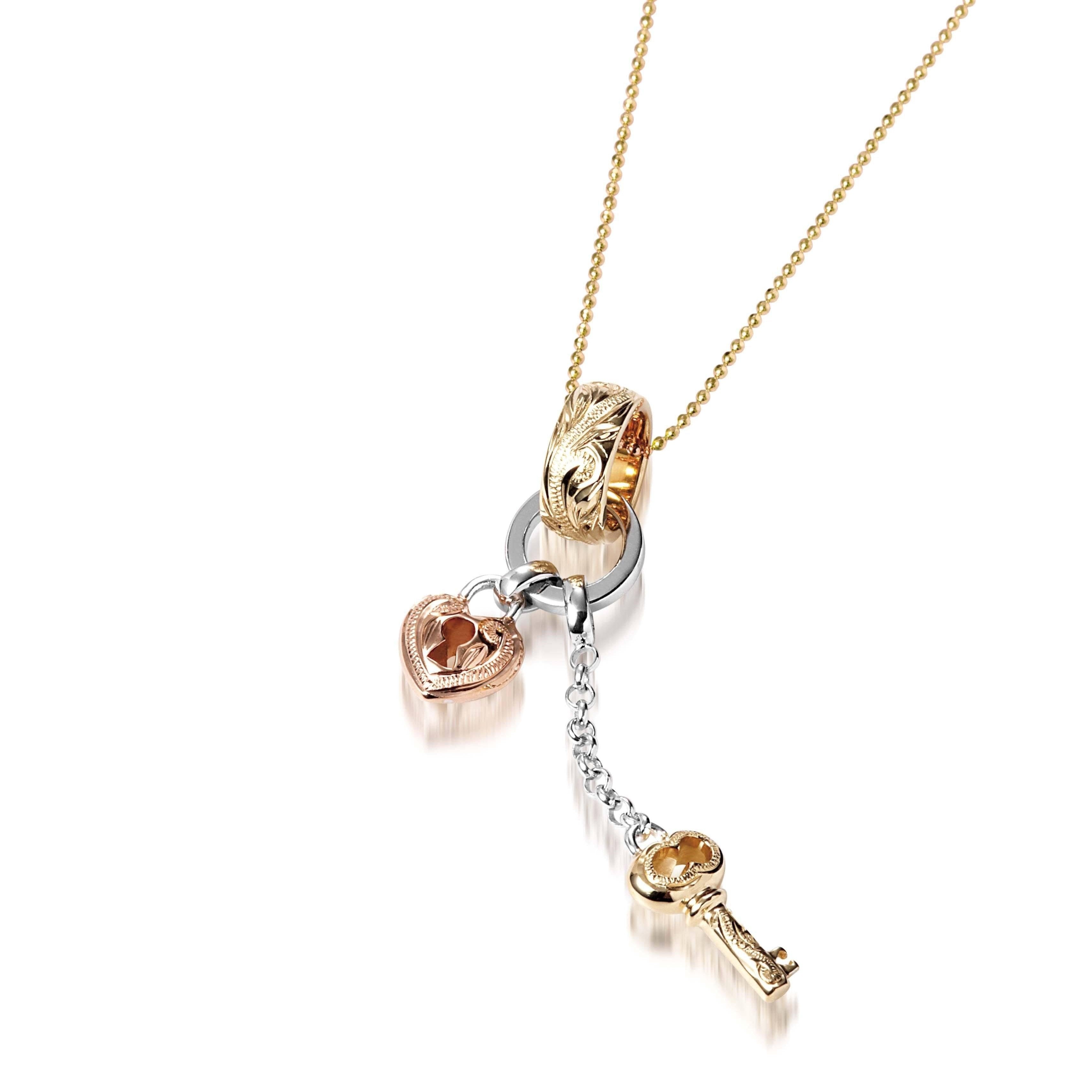 The picture shows a 14K yellow, rose, and white gold key and lock charm pendant with hand engravings.
