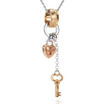 The picture shows a 14K yellow, rose, and white gold key and lock charm pendant with hand engravings.