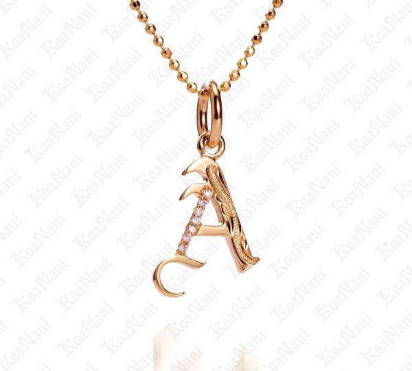 The picture shows a 14K yellow gold Koa Nani A initial pendant.