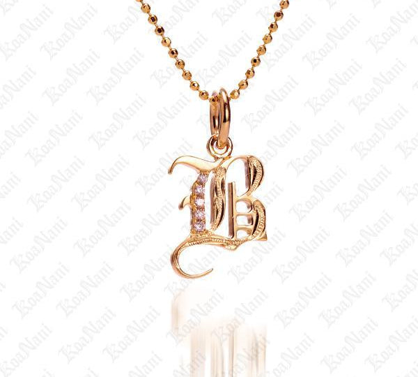 The picture shows a 14K yellow gold Koa Nani B initial pendant.