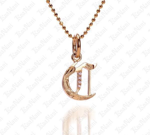 The picture shows a 14K yellow gold Koa Nani C initial pendant.