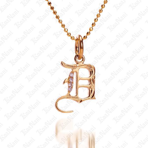 The picture shows a 14K yellow gold Koa Nani D initial pendant.