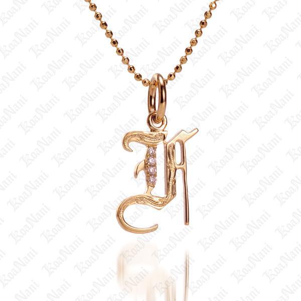 The picture shows a 14K yellow gold Koa Nani F initial pendant.