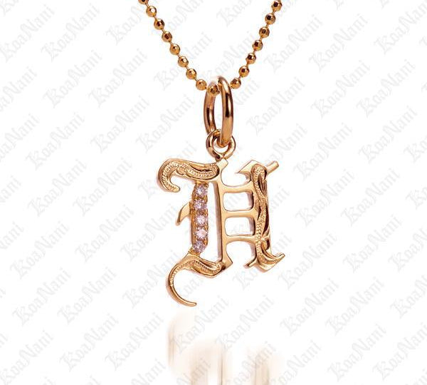 The picture shows a 14K yellow gold Koa Nani H initial pendant.