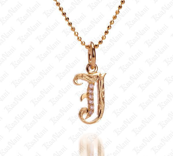 The picture shows a 14K yellow gold Koa Nani J initial pendant.