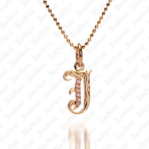 The picture shows a 14K yellow gold Koa Nani J initial pendant.