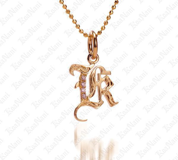 The picture shows a 14K yellow gold Koa Nani K initial pendant.