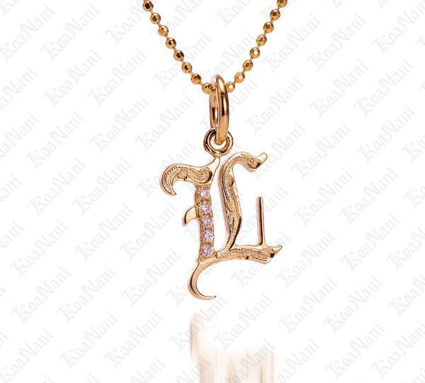 The picture shows a 14K yellow gold Koa Nani L initial pendant.