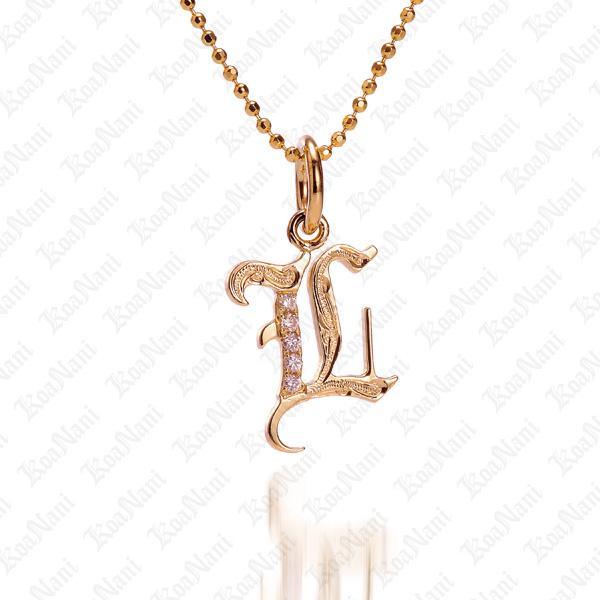 The picture shows a 14K yellow gold Koa Nani L initial pendant.