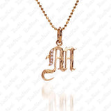The picture shows a 14K yellow gold Koa Nani M initial pendant.