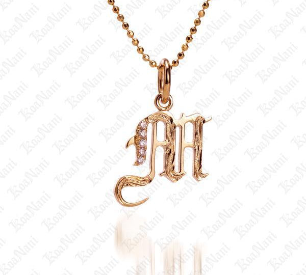 The picture shows a 14K yellow gold Koa Nani M initial pendant.