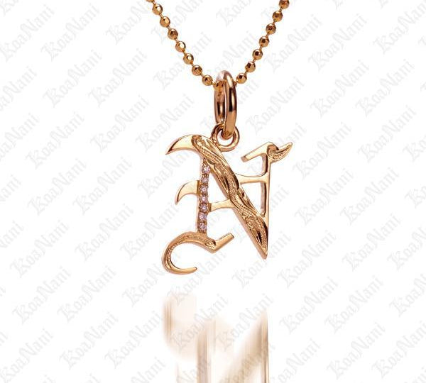 The picture shows a 14K yellow gold Koa Nani N initial pendant.