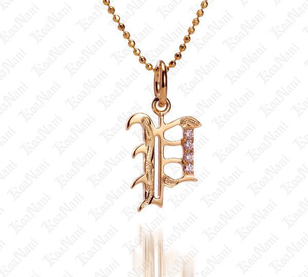 The picture shows a 14K yellow gold Koa Nani P initial pendant.