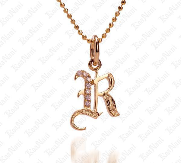 The picture shows a 14K yellow gold Koa Nani R initial pendant.