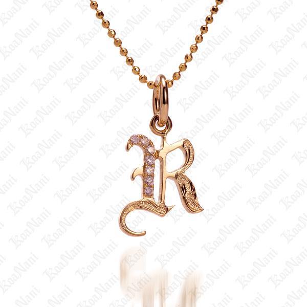 The picture shows a 14K yellow gold Koa Nani R initial pendant.