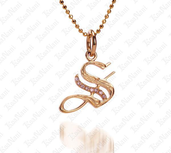 The picture shows a 14K yellow gold Koa Nani S initial pendant.