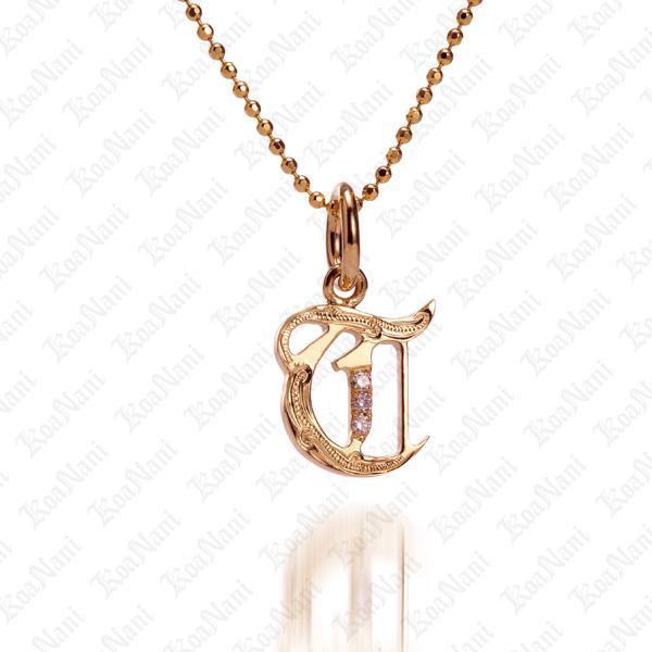 The picture shows a 14K yellow gold Koa Nani T initial pendant.