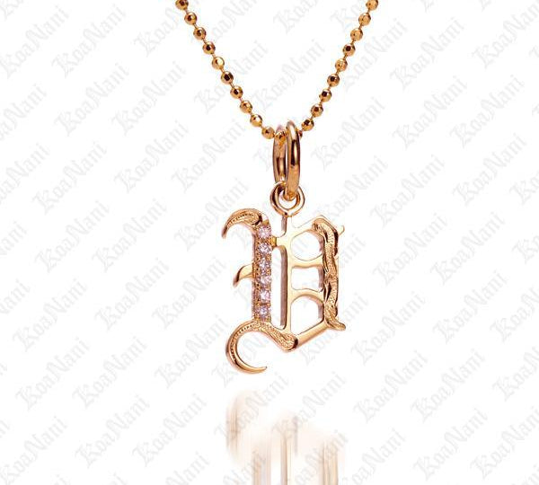 The picture shows a 14K yellow gold Koa Nani V initial pendant.