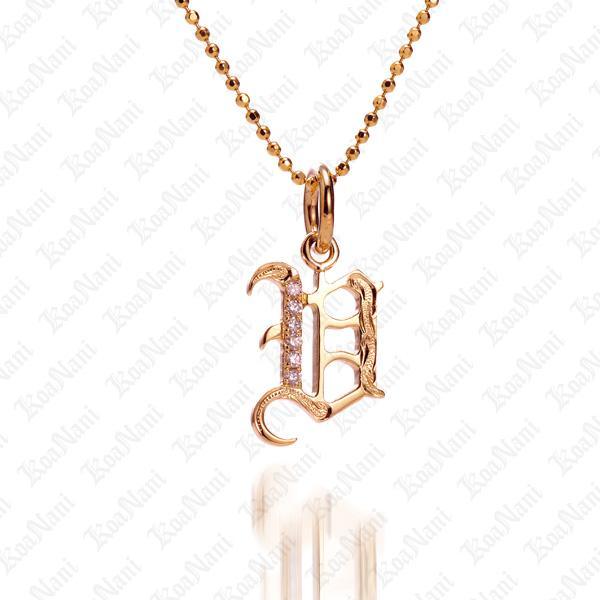The picture shows a 14K yellow gold Koa Nani V initial pendant.