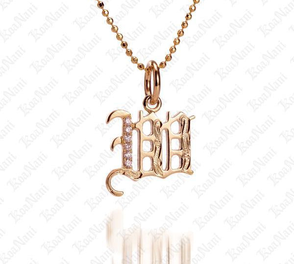 The picture shows a 14K yellow gold Koa Nani W initial pendant.