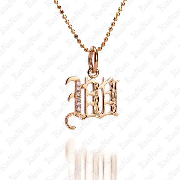 The picture shows a 14K yellow gold Koa Nani W initial pendant.