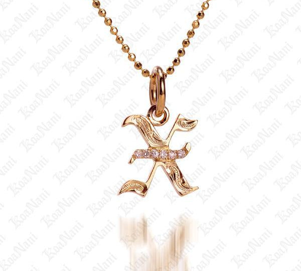 The picture shows a 14K yellow gold Koa Nani X initial pendant.