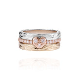 The picture shows a 14K white gold, yellow, and rose gold, tri-color rings. The rose gold heart ring features diamonds.