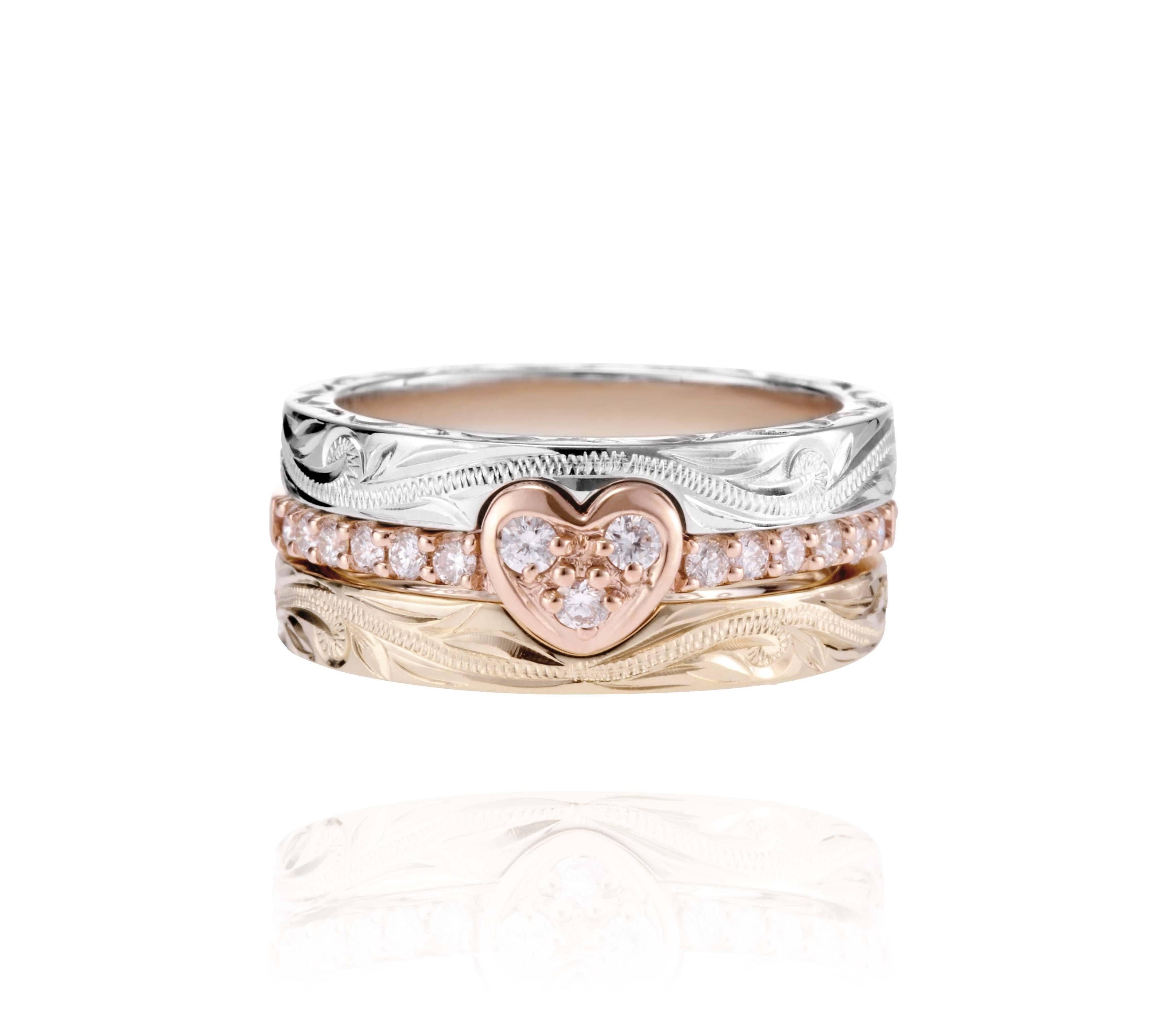The picture shows a 14K white gold, yellow, and rose gold, tri-color rings. The rose gold heart ring features diamonds.