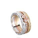 The picture shows a 14K white gold, yellow, and rose gold, tri-color rings. The rose gold heart ring features diamonds.