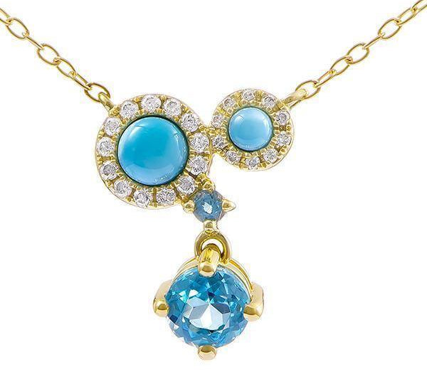 The photo shows a 14K yellow gold constellation pendant with two larimar gems, two aquamarine gems, and diamonds.