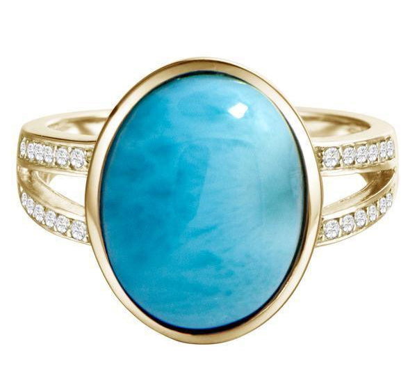 The picture shows a 14K yellow gold larimar cocktail ring with a split band lined with diamonds and topaz gemstones