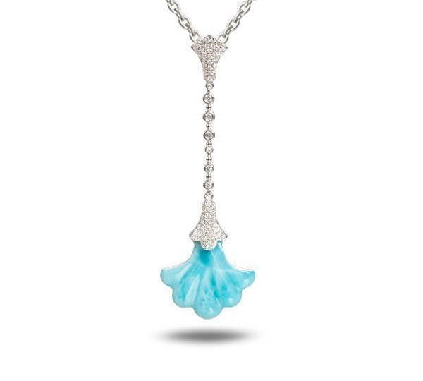 In this photo there is a white gold Hawaiian lily pendant with a blue larimar gemstone and diamonds.
