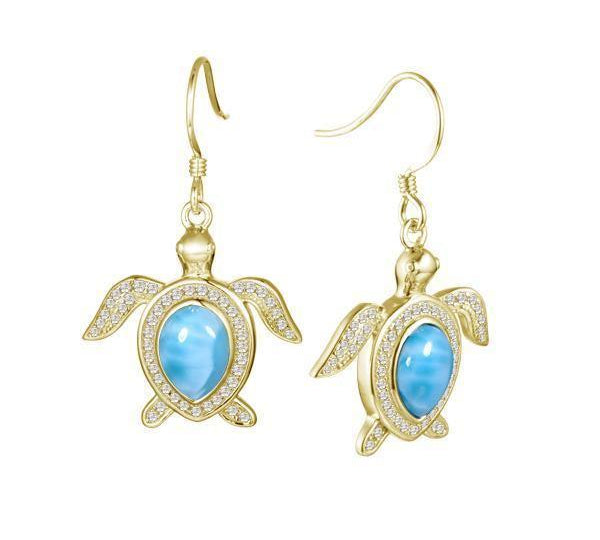 The picture shows a pair of 14K yellow gold sea turtle hook earrings with larimar gemstones and pavé diamonds.