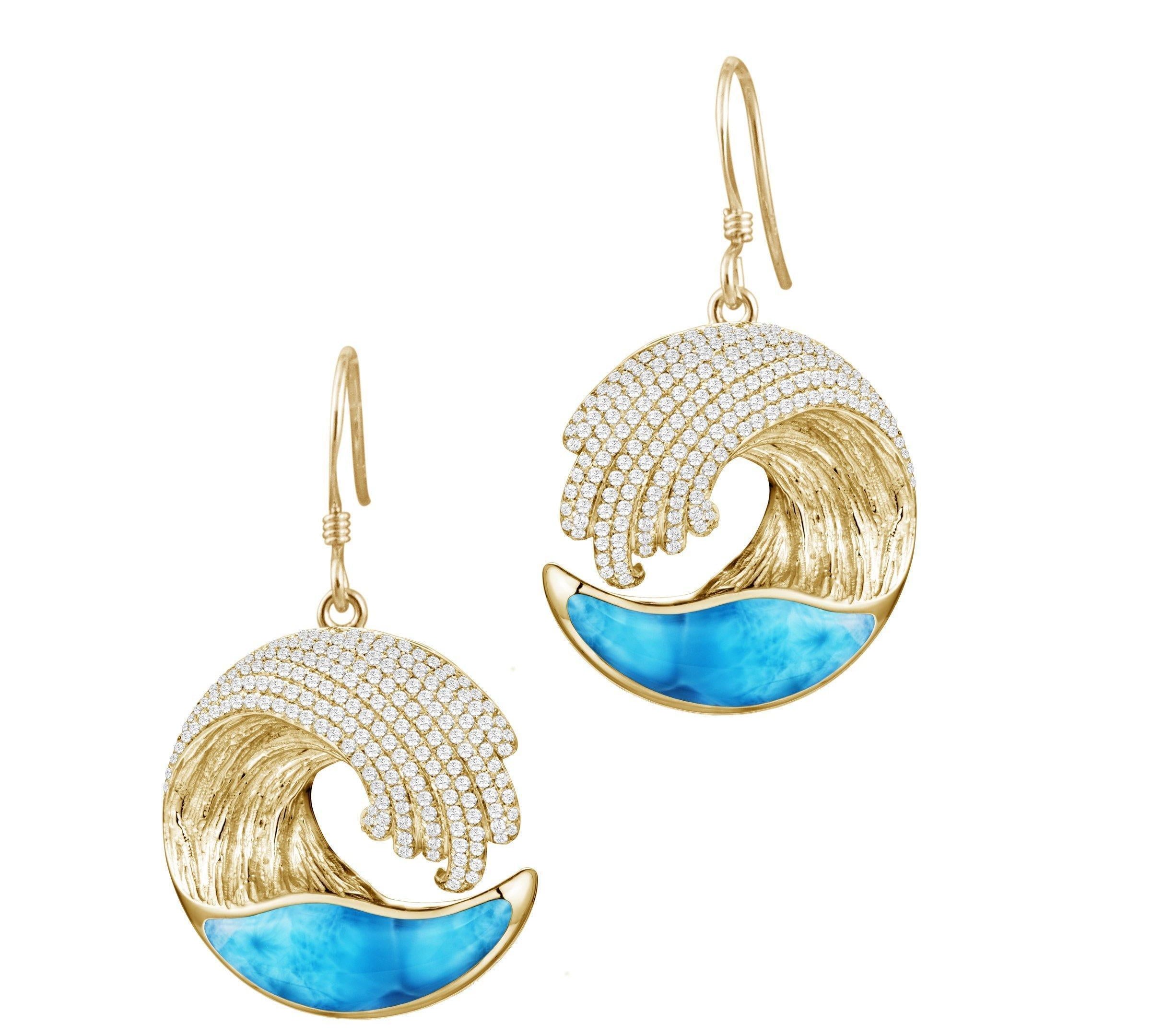 This picture shows 14k yellow gold larimar ocean wave earrings with diamonds.