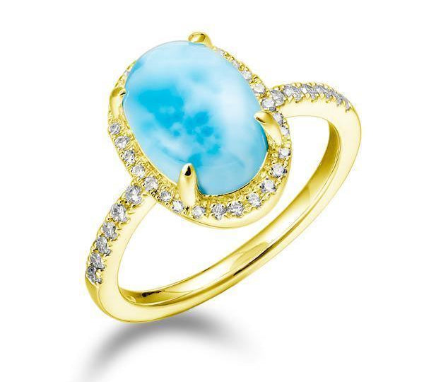 The picture shows a 14K yellow gold larimar oval ring with a diamond band.