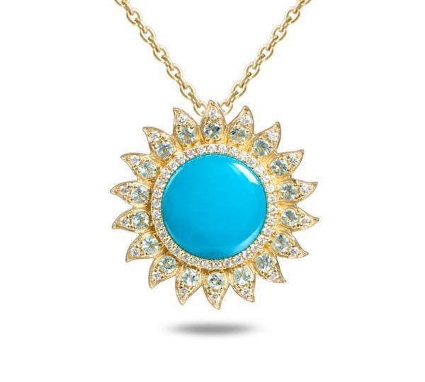 In this photo there is a yellow gold sunflower pendant with one blue larimar gemstone, diamonds and aquamarine.